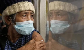 Một phụ nữ ngồi theo dõi sau tiêm vắc xin ở thành phố Quezon (Philippines) ngày 29/11. Ảnh: AP