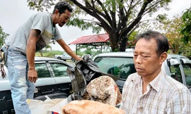 Ông Naris Suwannasang cầm khối u quý hiếm trên tay. 