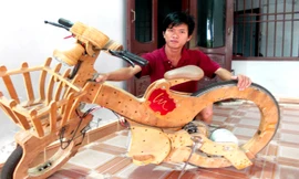 Huỳnh Phước Đức bên xe đạp điện không săm. Ảnh: N.T.