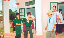 Thượng tá Nguyễn Văn Hạnh (trái) cùng đồng đội tham gia khám chữa bệnh miễn phí cho người dân