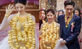 Trung Quốc: Cô dâu 'gây sốt' khi đeo 100 chiếc vòng vàng nặng trĩu cổ trong đám cưới