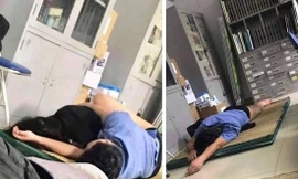 Bức ảnh lan truyền trên mạng xã hội về bác sĩ ôm nữ sinh viên thực tập ngủ tại Bệnh viện Hữu Nghị đa khoa Nghệ An. Ảnh: Facebook.