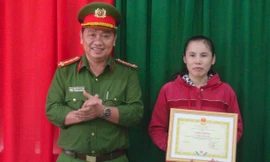 Đại tá Nguyễn Chí Công, trao giấy khen cho nữ tạp vụ. Ảnh: Anh Minh/Zing