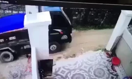 Xe tải chở cát lùi cán chết cháu bé. (Ảnh cắt từ clip)