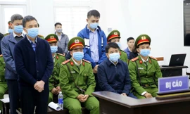 Bị cáo Nguyễn Đức Chung (ngồi) và 3 đồng phạm tại phiên xét xử. (Ảnh: TTXVN).