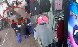 Khoảnh khắc vật thể lạ rơi trúng bàn ăn. Ảnh cắt từ clip.