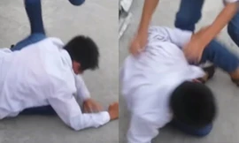 Nam sinh bị một nhóm liên tục đánh đấm và tát vào mặt.( Ảnh cắt từ clip, nguồn Internet)