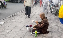 Giả dạng tu hành, thầy Sáu lê la trước cổng bệnh viện để xin tiền.