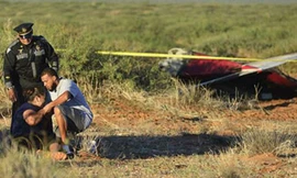 Người nhà của một trong số các nạn nhân khóc thảm thiết bên xác chiếc máy bay gặp nạn. Ảnh: AP