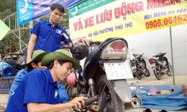  Các thanh niên tình nguyện vá xe miễn phí - Ảnh: Lê Thanh 