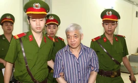 Dẫn giải bị cáo Nguyễn Đức Kiên đến tòa. Ảnh: TTXVN