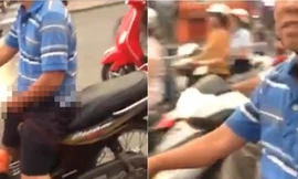 Kể cả khi dừng chờ đèn đỏ, người này cũng không dừng hành động khiếm nhã của mình lại, bất chấp đang bị nhiều người dòm ngó, ghi hình. 