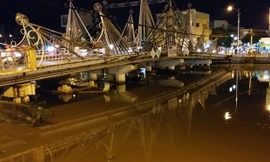 Nước dưới sông Maspéro đang dâng cao và sà lan và xe cẩu đã chìm. Ảnh: Việt Tường.