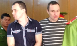 Khi bị dẫn giải ra xe, 2 bị cáo tỏ ra hung hăng. Ảnh: H. D.