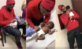 Antwon dỗ dành, ôm ấp con suốt thời gian bé đi tiêm. Ảnh: Facebook.