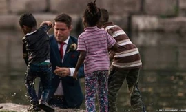 Bé trai được chú rể Clayton đưa lên bờ sau khi bị ngã xuống nước (Ảnh: BBC)