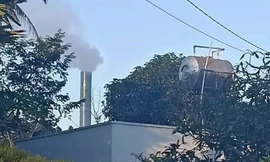 Ống khói đen khịt của cơ sở chế biến cà phê đặt trong khu dân cư