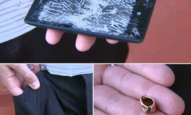 Viên đạn của tên cướp đã bị chiếc Lumia 520 đẩy lệch đường bay. Màn hình của thiết bị này cũng nứt nẻ nghiêm trọng. Ảnh: Globo.