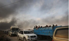 Nhiều dân thường sơ tán khi khói bay lên từ biên giới Syria - Thổ Nhĩ Kỳ. (Ảnh: BBC)