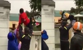 Phụ huynh bế trẻ vượt tường vào lớp giữa trời rét căm căm