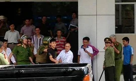 Đối tượng (áo trắng) bị dẫn giải về cơ quan công an để tiếp tục điều tra