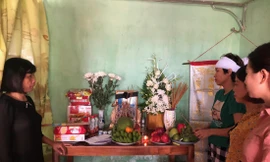 Chị Nguyễn Thị Thu (bên trái) trước bàn thờ của con trai. Ảnh: H.L
