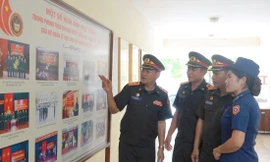 Trung tá Thanih Bounnao (ngoài cùng bên trái) cùng một số thành viên trong đoàn sĩ quan trẻ Lào trao đổi sau một buổi tập huấn tại Đoàn 871, Tổng cục Chính trị QĐND Việt Nam. ẢNH: NGUYỄN MINH