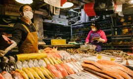 Một người bán hải sản mời chào khách hàng ở chợ Sanyuanli, Bắc Kinh vào tháng Hai (Ảnh: Global Times)