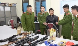 Giàng A Lề cùng số tang vật tại cơ quan công an.