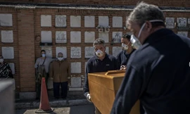 Ông bố và cô con gái dự đám tang người thân của mình ở Madrid, Tây Ban Nha, ngày 28/3. (Ảnh: AP)