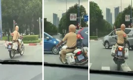 Cán bộ CSGT liên tục ra hiệu cho các phương tiện khác nhường đường cho ô tô chở thai phụ.