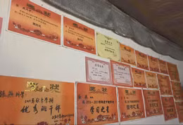 Những bức tường trong ngôi nhà đơn sơ của Zhang được treo kín giấy khen thành tích học tập mà cô đã đạt được. Ảnh: SCMP