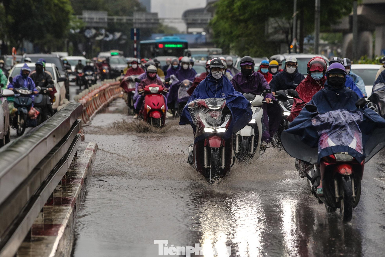 Vũng nước trên cầu vượt Ngã Tư sở khiến các phương tiện di chuyển khó khăn.