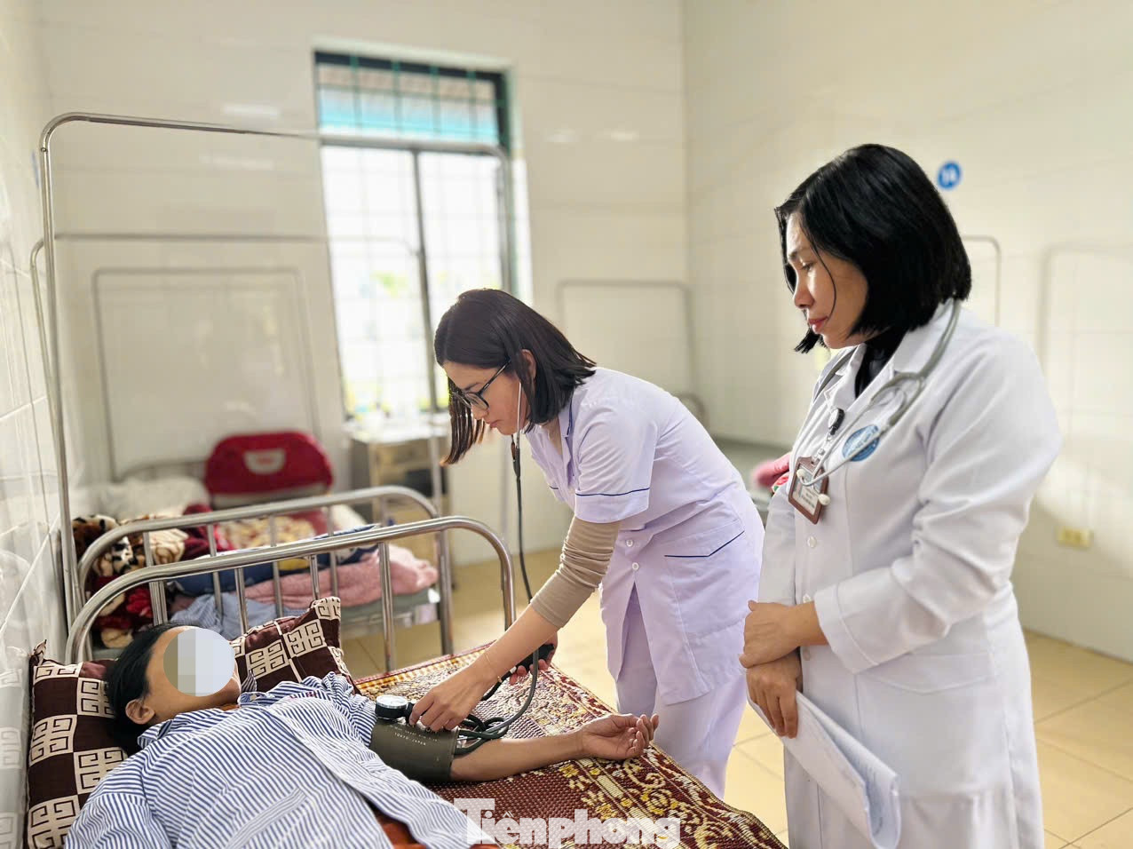 Bác sĩ Lê Thị Quỳnh Nga cùng nhân viên y tế khám bệnh cho bệnh nhân.