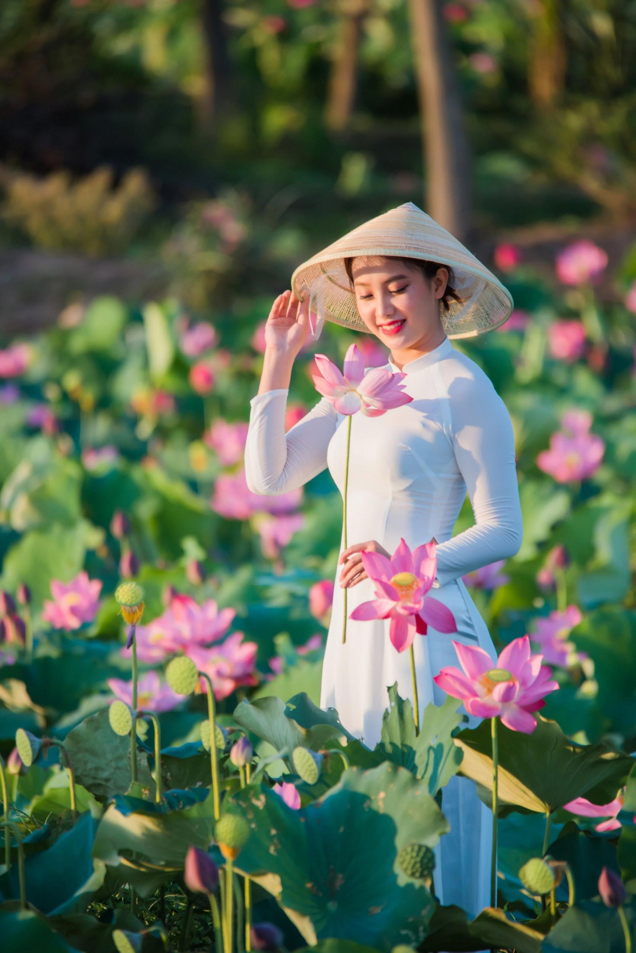 Du khách đến đây ai cũng muốn lưu lại những bức hình kỷ niệm với đồng sen nở rộ trong nắng mai. Ảnh: Nguyễn Trình.