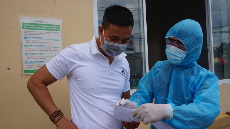 Cán bộ y tế ghi thông tin tài xế qua chốt kiểm dịch.