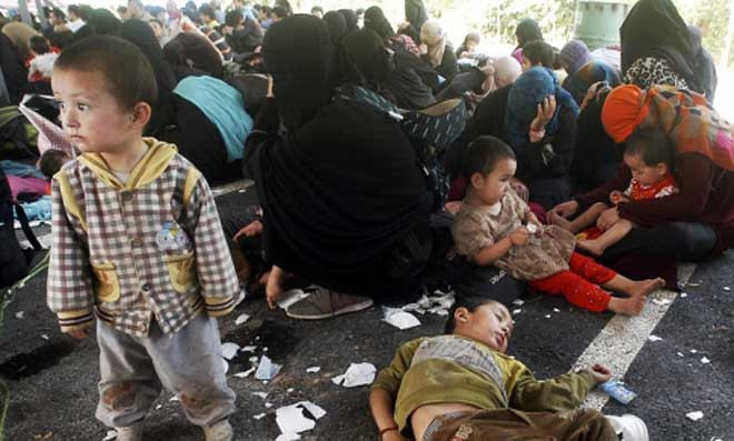 Những phụ nữ đang cố gắng che mặt sau khi bị bắt từ khu vực trồng cao su ở miền nam Thái Lan.