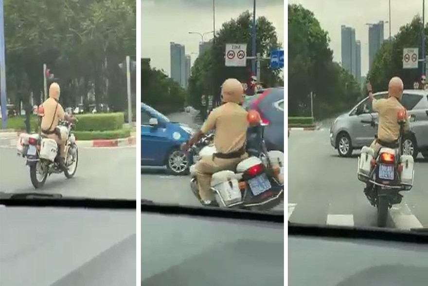 Cán bộ CSGT liên tục ra hiệu cho các phương tiện khác nhường đường cho ô tô chở thai phụ.