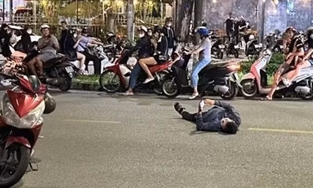 Người đàn ông nằm giữa đường xem điện thoại khi bị đo nồng độ cồn