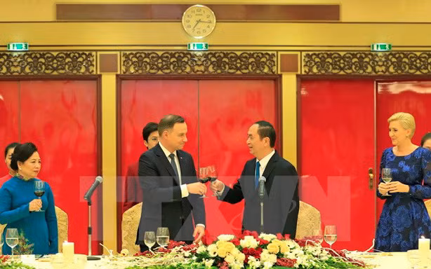 Chủ tịch nước Trần Đại Quang và Phu nhân cùng Tổng thống Cộng hòa Ba Lan Andrzej Duda và Phu nhân nâng cốc. Ảnh: Nhan Sáng/TTXVN.