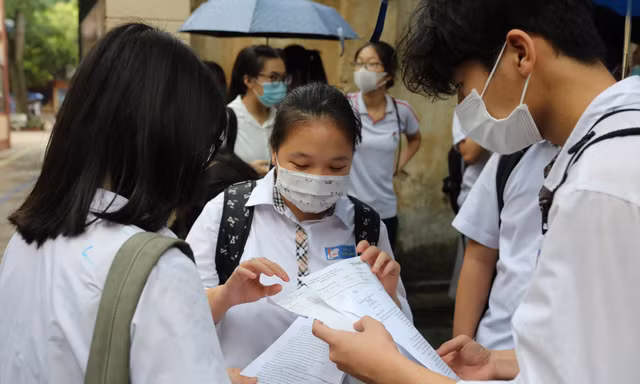 Thí sinh trao đổi môn tiếng Anh tại điểm thi Trường THPT Trần Phú sang 12/6. Ảnh: Như Ý 