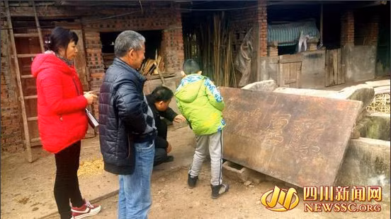 Hàng xóm nhà lão nông Zhangxing tò mò xem tấm bảng gỗ.