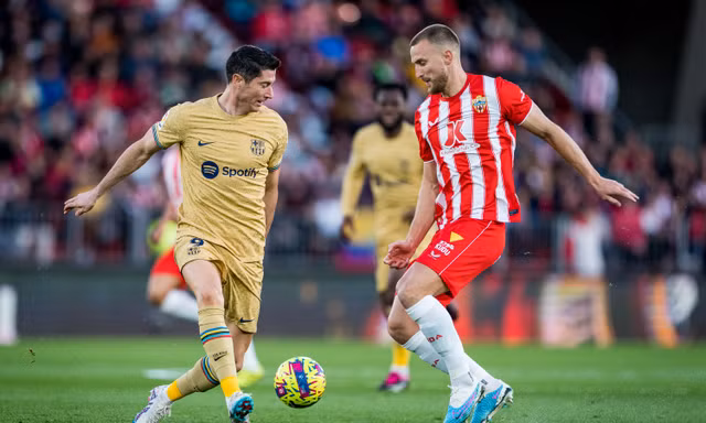 Lewandowski tranh chấp với cầu thủ Almeria trong trận đấu vào mùa giải trước.