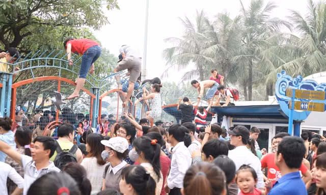 Cảnh hỗn loạn, vượt rào sắt vào trong công viên Hồ Tây trong ngày mở cửa miễn phí.