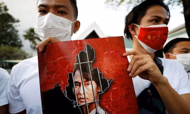 Người Myanmar cầm ảnh bà Suu Kyi biểu tình ở Bangkok (Thái Lan). Ảnh: Reuters