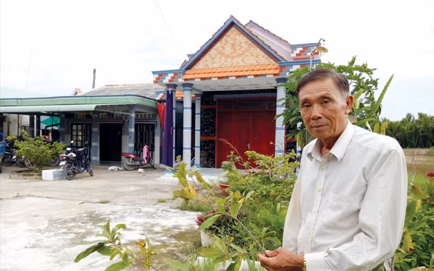 Ông Nguyễn Văn Danh chăm sóc kiểng trước nhà. Ảnh: Hòa Hội.