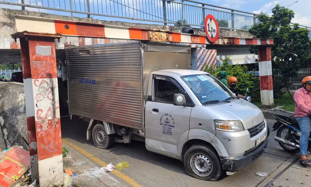 Chui qua thanh giới hạn chiều cao, xe tải mắc kẹt dưới cầu ở TPHCM