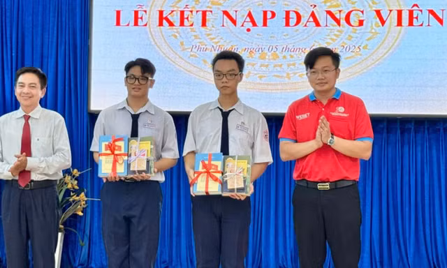 Hai chiến sĩ Hoa phượng đỏ: Đức Huy, Công Thành (đứng giữa) tại lễ kết nạp Đảng, ngày 5/6