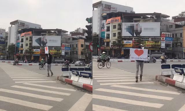 Anh chàng ngoại quốc cầm biển hiệu “Tất cả sẽ ổn thôi” động viên người dân Hà Nội mùa dịch