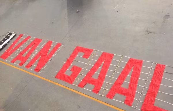 CĐV M.U chuẩn bị biểu ngữ yêu cầu sa thải Van Gaal. 